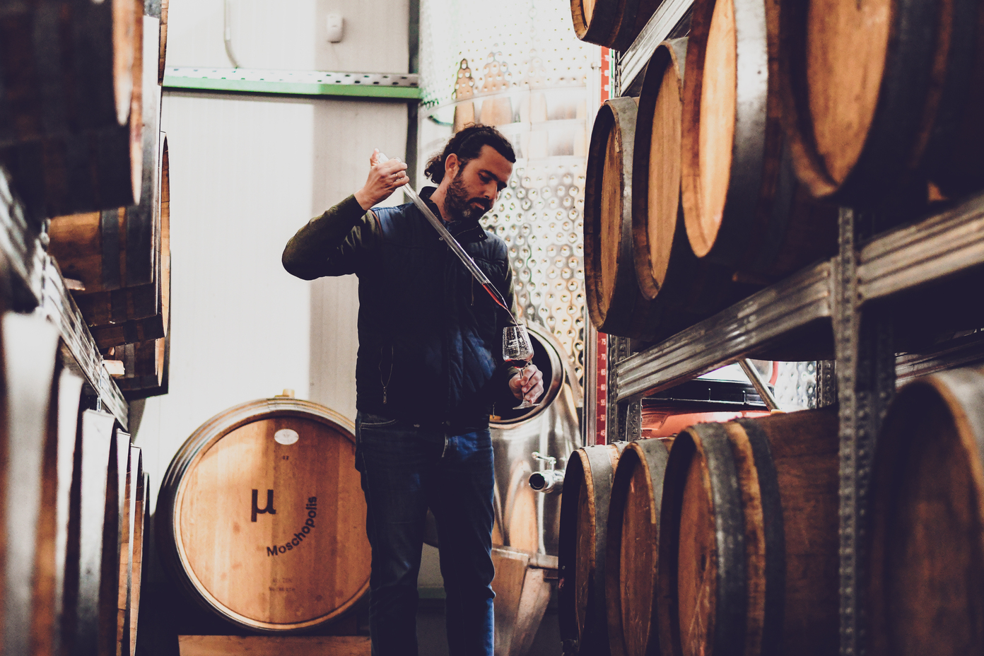 Moschopolis winery wine barrels and a man