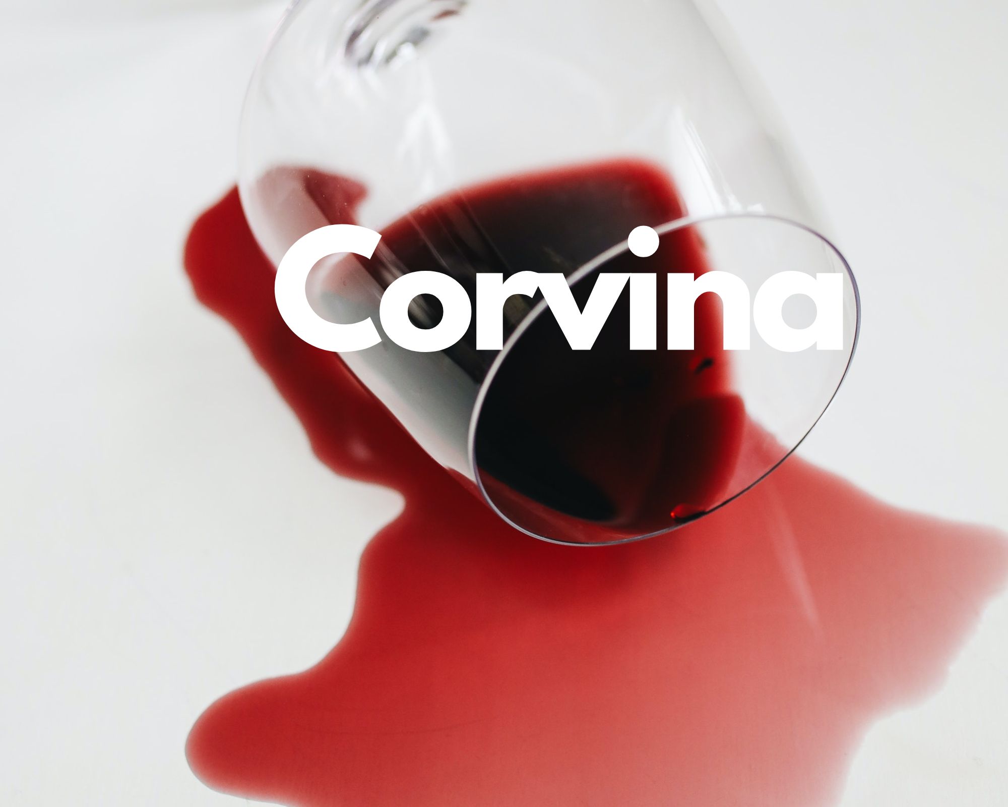 A glass of spilled red wine in a white background, Italian grape varieties