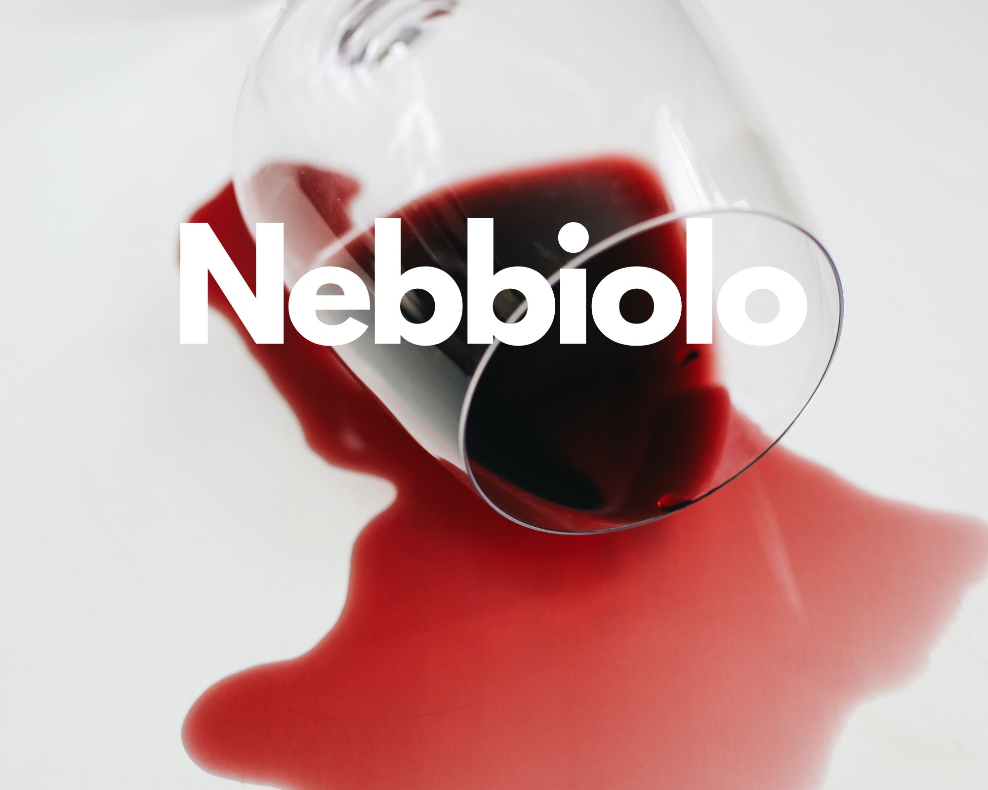 A glass of spilled red wine in a white background, Italian grape varieties