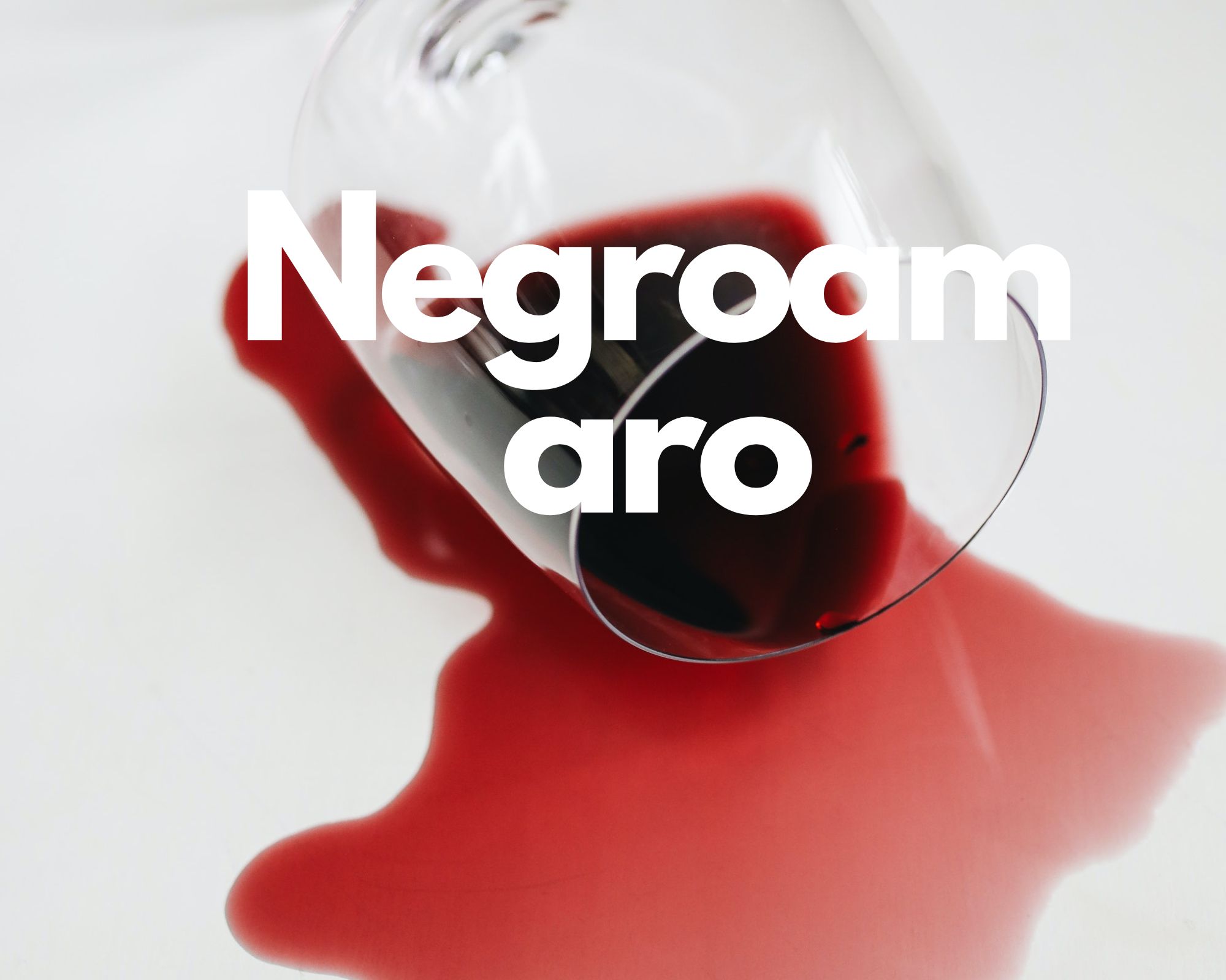 A glass of spilled red wine in a white background, Italian grape varieties