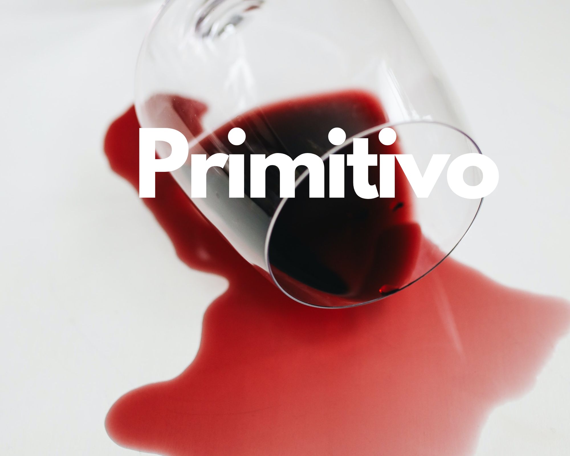 A glass of spilled red wine in a white background, Italian grape varieties