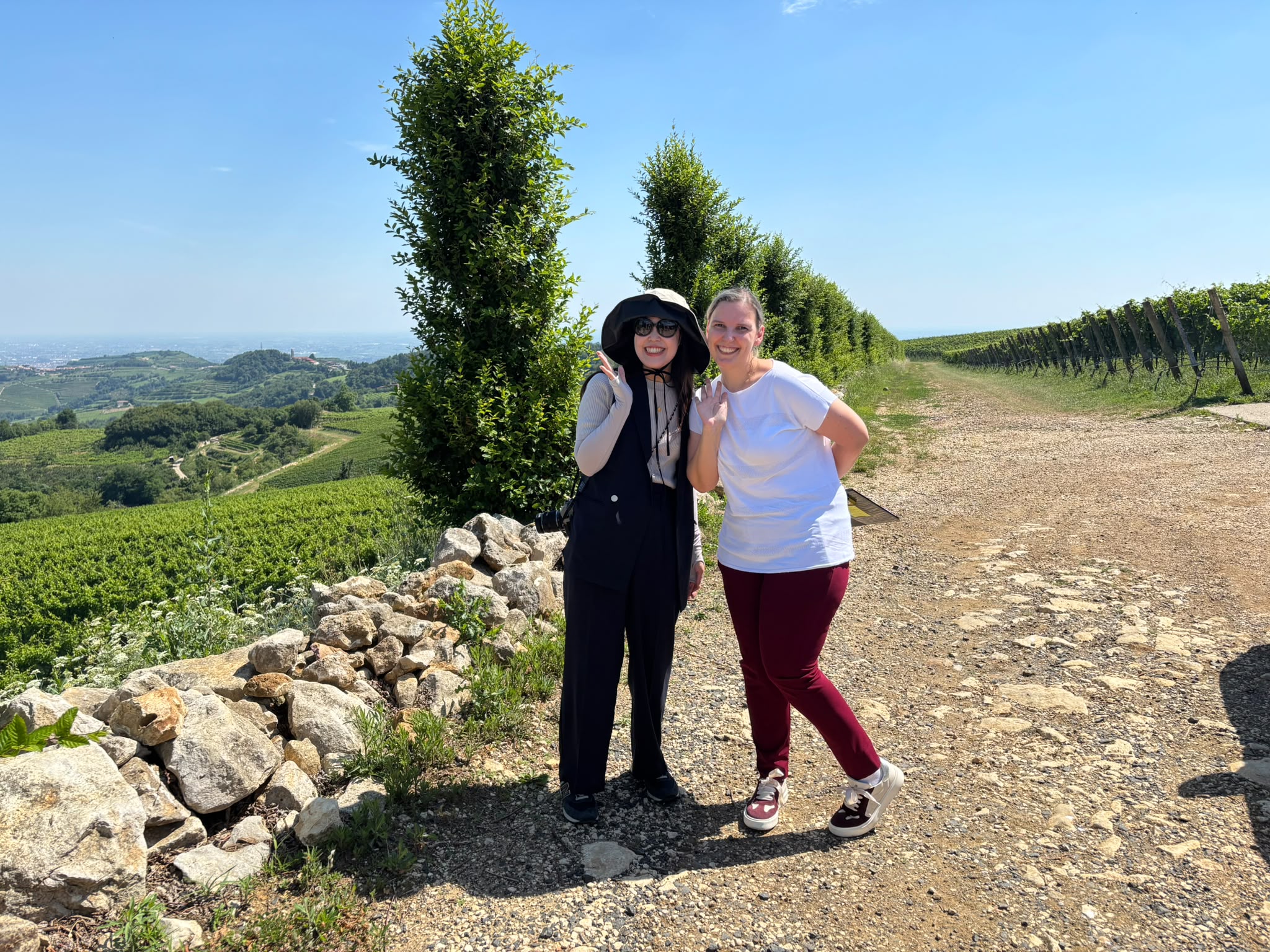 Two women are smiling in the countryside