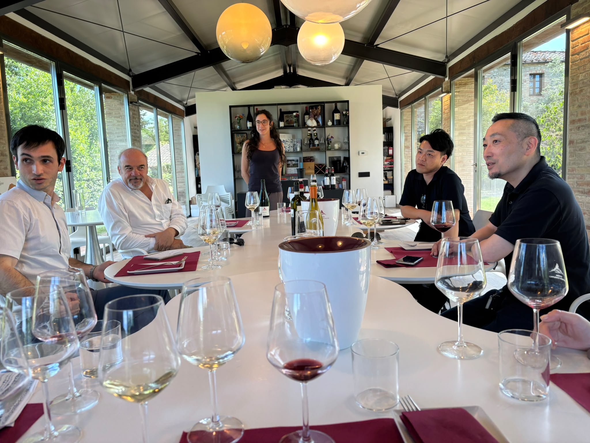 Several people around a table tasting wines