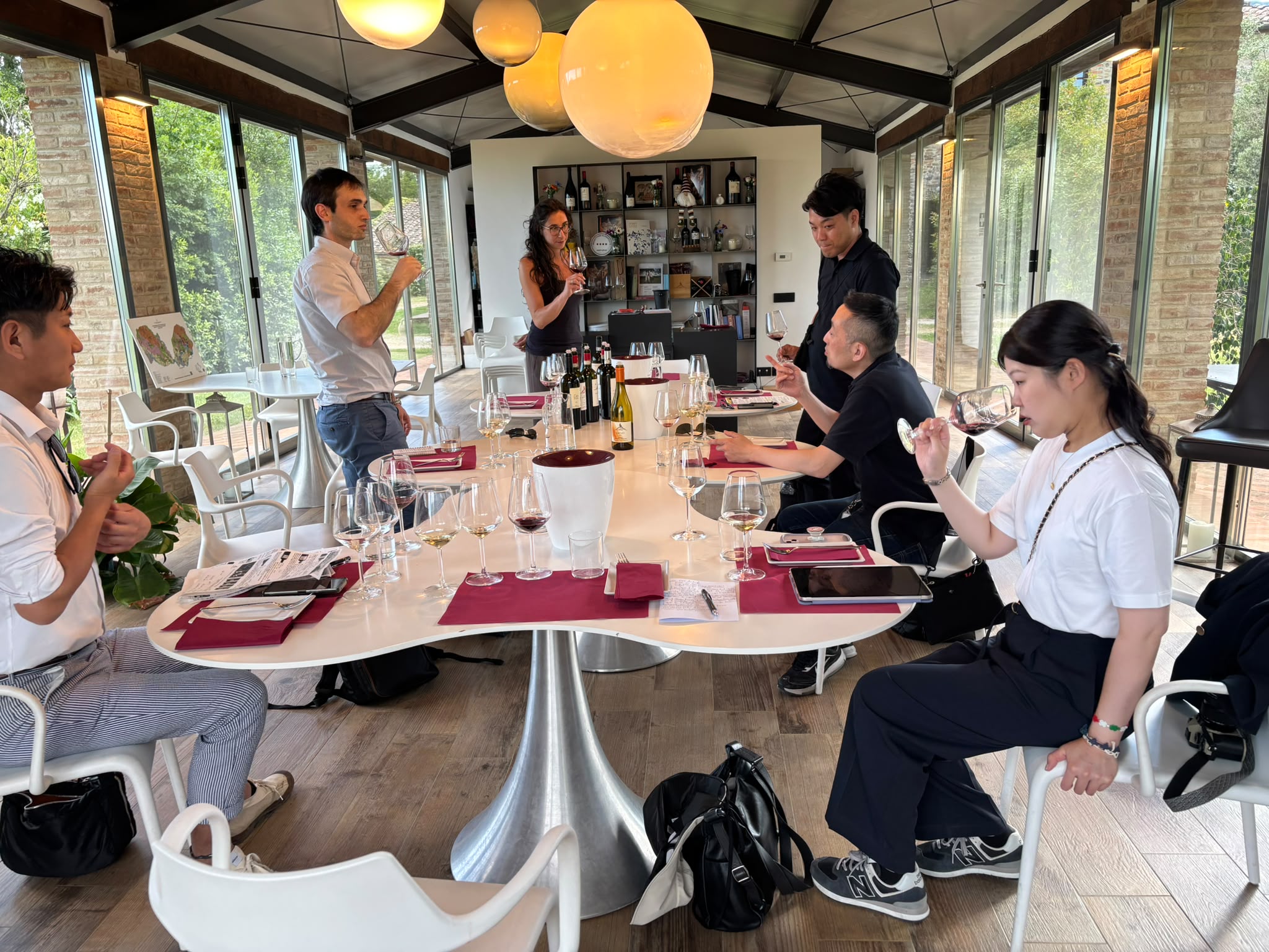 Several people around a table tasting wines